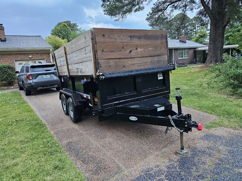 Dump trailer tilting to unload at a job site