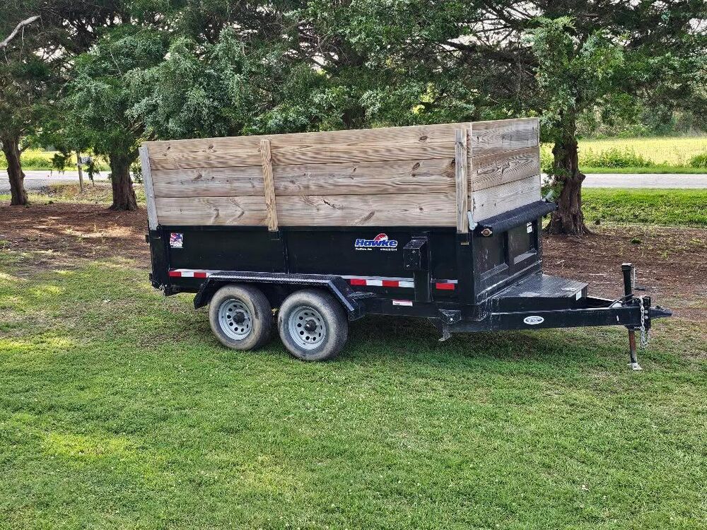 Thomas Enterprises dump trailer with high wood sides, ready on site